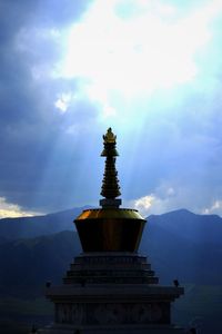 Low angle view of monument against cloudy sky