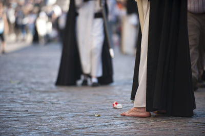 Low section of people standing on street