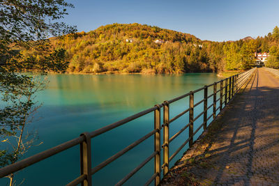 Scenic view of lake by trees against sky