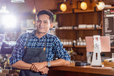 Portrait of a young man smiling in restaurant