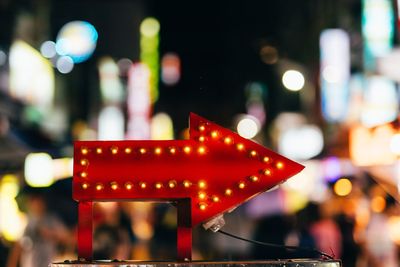 Defocused image of illuminated lights in city at night