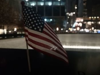 Close-up of flags against illuminated wall at night