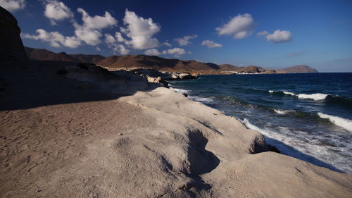 Scenic view of sea and mountains against sky