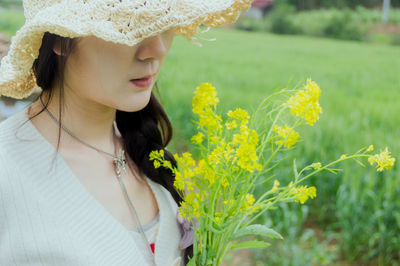 Close-up of young woman wearing hat