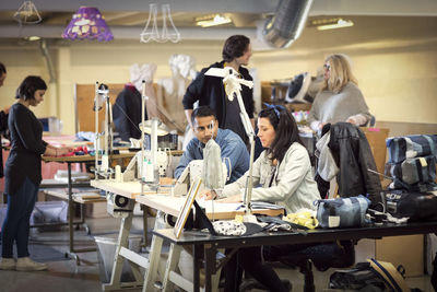 Volunteers discussing while working at workshop