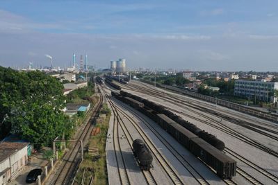 High angle view of railroad tracks in city against sky