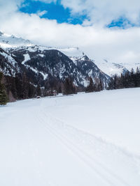 Scenic view of snow covered mountains against sky