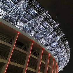 Low angle view of illuminated ferris wheel against sky