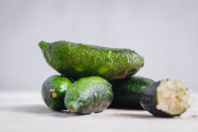 Close-up of fruits on table against white background