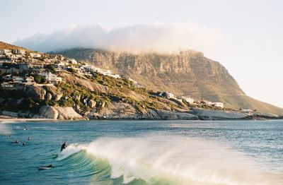 Scenic view of sea and mountains against sky