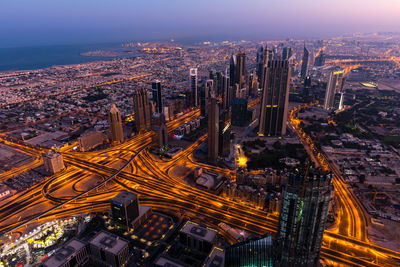 Aerial view of illuminated buildings in city at night