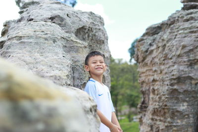 Portrait of boy standing on rock