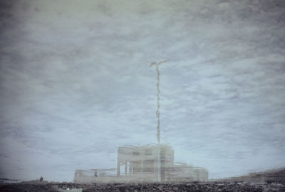 Low angle view of building against cloudy sky