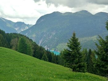 Scenic view of mountains against cloudy sky