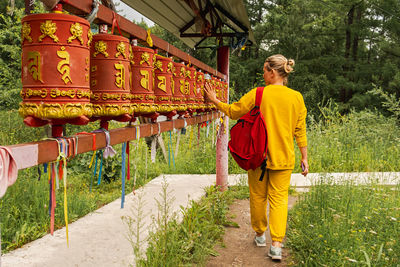 Rear view of woman walking on footpath