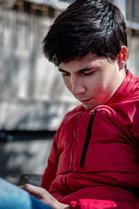 Close-up of man sitting outdoors