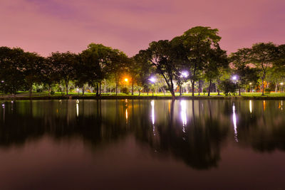 Scenic view of lake against sky at night