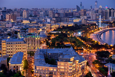 High angle view of illuminated buildings in city at night