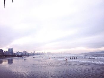 View of beach with city in background