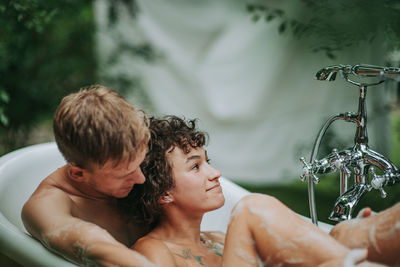 Couple in bathtub outdoors