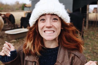 Portrait of smiling mature woman wearing warm clothing at farm