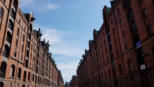 Low angle view of buildings against blue sky