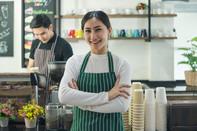 Portrait of a smiling young woman standing in store