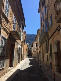 Narrow alley amidst buildings in city