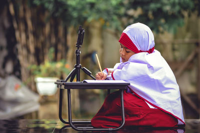 Side view of a boy playing outdoors