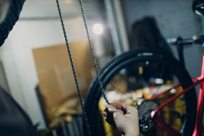 Cropped image of man repairing bicycle