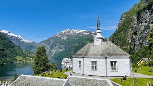 Church by mountain against blue sky