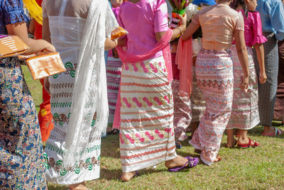 Rear view of woman standing on field