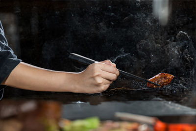 Cropped hand of man preparing food