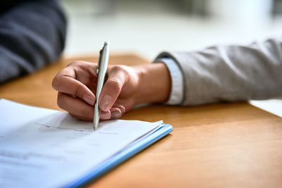 Midsection of man working on table