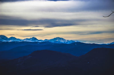 Scenic view of silhouette mountains against sky at sunset