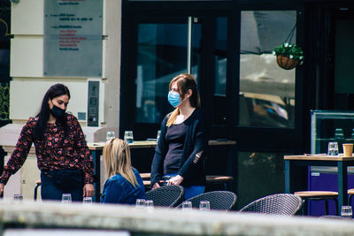 Young woman sitting on table at restaurant