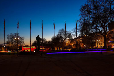 Illuminated city against clear sky at night