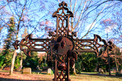 Low angle view of metal structure in park against sky