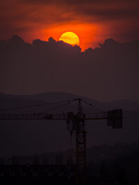 Silhouette mountains against orange sky