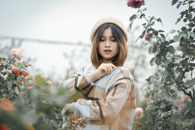 Full length of girl standing against trees