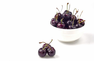 Close-up of cherries on white background