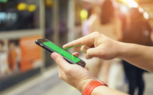 Close-up of hand holding mobile phone