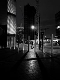 Man walking on illuminated city at night