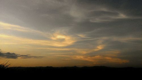 Scenic view of landscape against cloudy sky