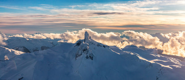 Scenic view of snowcapped mountains against sky during sunset