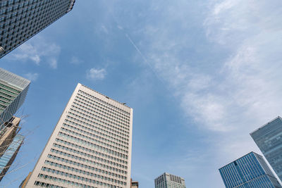 Low angle view of modern buildings in city against sky