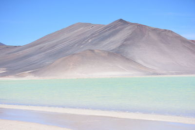 Scenic view of mountain against blue sky