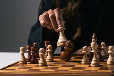 Midsection of woman playing chess