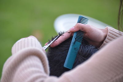 Close-up of woman cutting hair