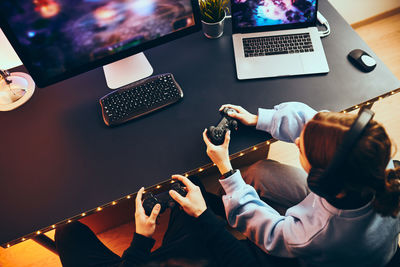 Midsection of woman using laptop on table